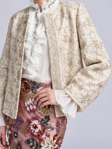 Social Queen Floral Appliqué Embroidered Jacket worn over a white ruffled blouse and a skirt with colorful beaded floral detail.