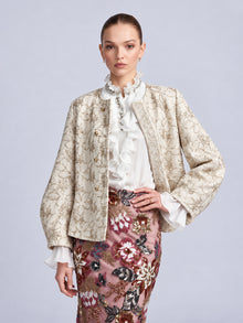 Social Queen Floral Appliqué Embroidered Jacket in beige with tonal embroidery and gold buttons, worn over a white ruffled blouse and a pink skirt with colorful floral appliqué.