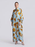 A model wears a light blue long-sleeved Social Queen Floral Print Maxi Shirtdress (Tie Included) featuring a yellow floral pattern in a relaxed silhouette.