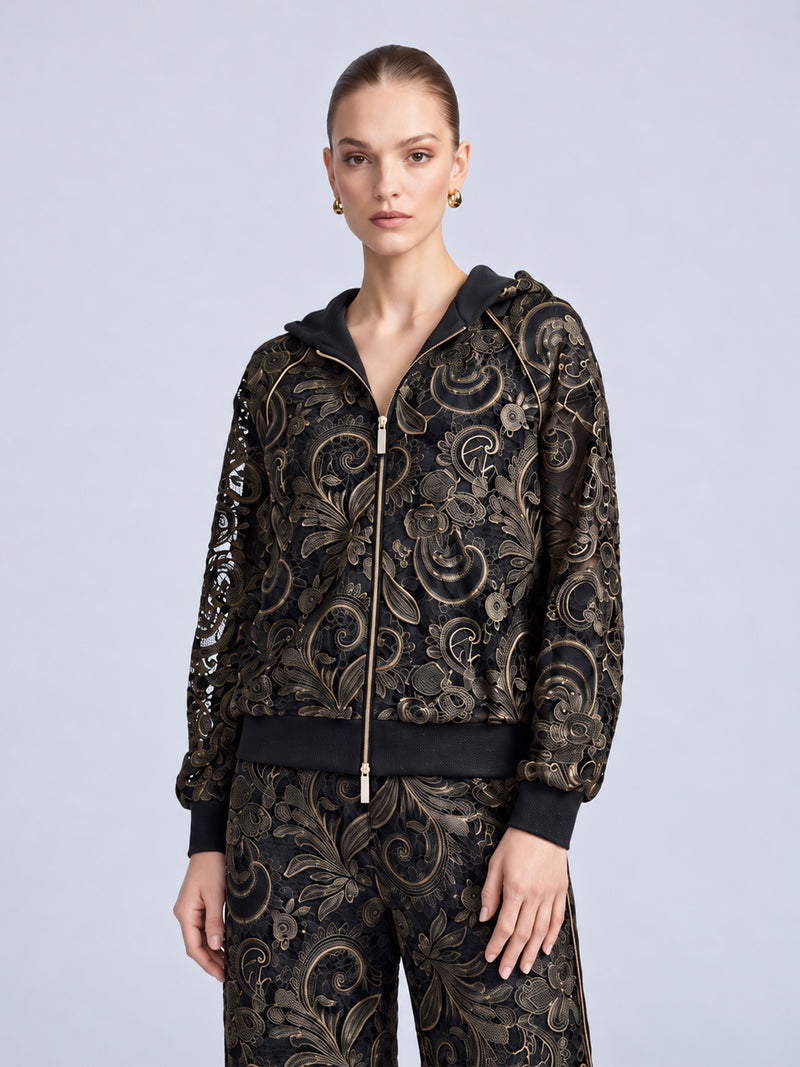 A model wearing a Social Queen Paisley Embroidered Lace Hooded Jacket in black, crafted from cutout lace with a gold-tone paisley pattern.