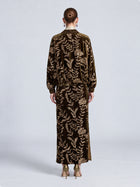Back view of a person wearing a matching olive green Social Queen Sequin Embroidered Velvet Midi Skirt and jacket with gold floral embroidery, paired with gold high heels.
