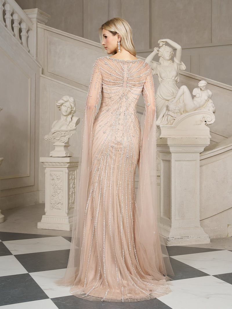 A woman in the Social Queen Artisanal Gilded Beaded Tulle Gown stands on a checkered floor, facing away, with white classical statues and a staircase in the background.