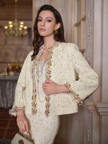 A woman stands indoors wearing the Social Queen Beaded Floral Embroidered Tweed Jacket, paired with layered necklaces and a handbag.