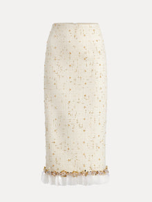The Social Queen Beaded Floral Embroidered Tweed Skirt is cream-colored, knee-length, with gold and 3D floral embellishments and a sheer white ruffled hem.