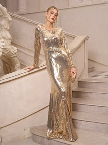 Woman in the Social Queen Beaded Gold-Accent Crystal Gown, holding a matching clutch on an ornate staircase—an elegant pick for wedding guests or formal evening events.
