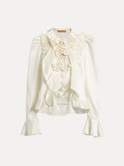 The Beaded Ruffle Satin Blouse by Social Queen features a cream satin finish, puff sleeves, hand-stitched ruffles, lace accents, a high collar, and flared cuffs.