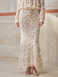 A person wears the Social Queen Beaded Sequin Mermaid Elastic Skirt with a matching top and gold open-toe heels, standing on a light tiled floor indoors.