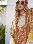 A woman in sunlight stands near a white wall and palm leaves, wearing Social Queen's Boho Lace Floral Print Dress along with sunglasses and a patterned headscarf.