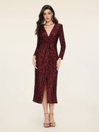 A woman models the Social Queen Burgundy Sequin V-Neck Slit Dress, featuring a ruched waist, midi length, and front slit, against a plain light background.