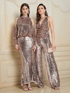 Two women wear Social Queen sequin styles: one in a long, shiny off-shoulder dress; the other in the Champagne Sequin Off-Shoulder Top with matching wide-leg pants. Both finish their looks with metallic sandals.