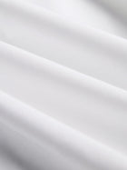 Close-up of the Cropped Embroidered Lace Panel Blouse by Social Queen, showing smooth white fabric with gentle folds and delicate hand-stitched lace accents.