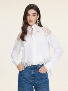 A woman wears the Social Queen Cropped Embroidered Lace Panel Blouse with blue jeans, standing against a plain light background.