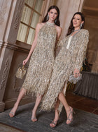 Two women pose indoors, smiling for the camera in Social Queen’s Crystal-Embellished Sequin Fringe Halter Dresses and heels, each holding a metallic clutch bag.