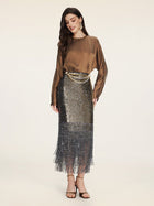 A woman in a Social Queen Crystal-Embellished Tencel Satin Blouse, metallic sequin fringe skirt, gold chain belt, and heeled sandals stands against a plain light background.