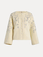 The Crystal Leaf Embroidered Wool Coat by Social Queen features pearl buttons, pearl accents, and silver floral embroidery with leaf-patterned sequins on the front and sleeves.