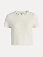 The Social Queen Crystal & Sequin Knit Textured Crop Top is a minimalist cream short-sleeve top with a round neckline and sparkling rhinestone accents.