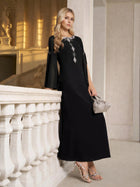 A woman stands by a white railing in an elegant indoor setting, wearing the Social Queen Elegant Beaded Split-Sleeve Dress, paired with silver heels and a small silver handbag.