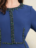 A close-up of the Social Queen Elegant Hand-Beaded Green Crystal Dress, a royal blue midi with green crystal embellishments on the neckline and bodice, plus a fitted waist.