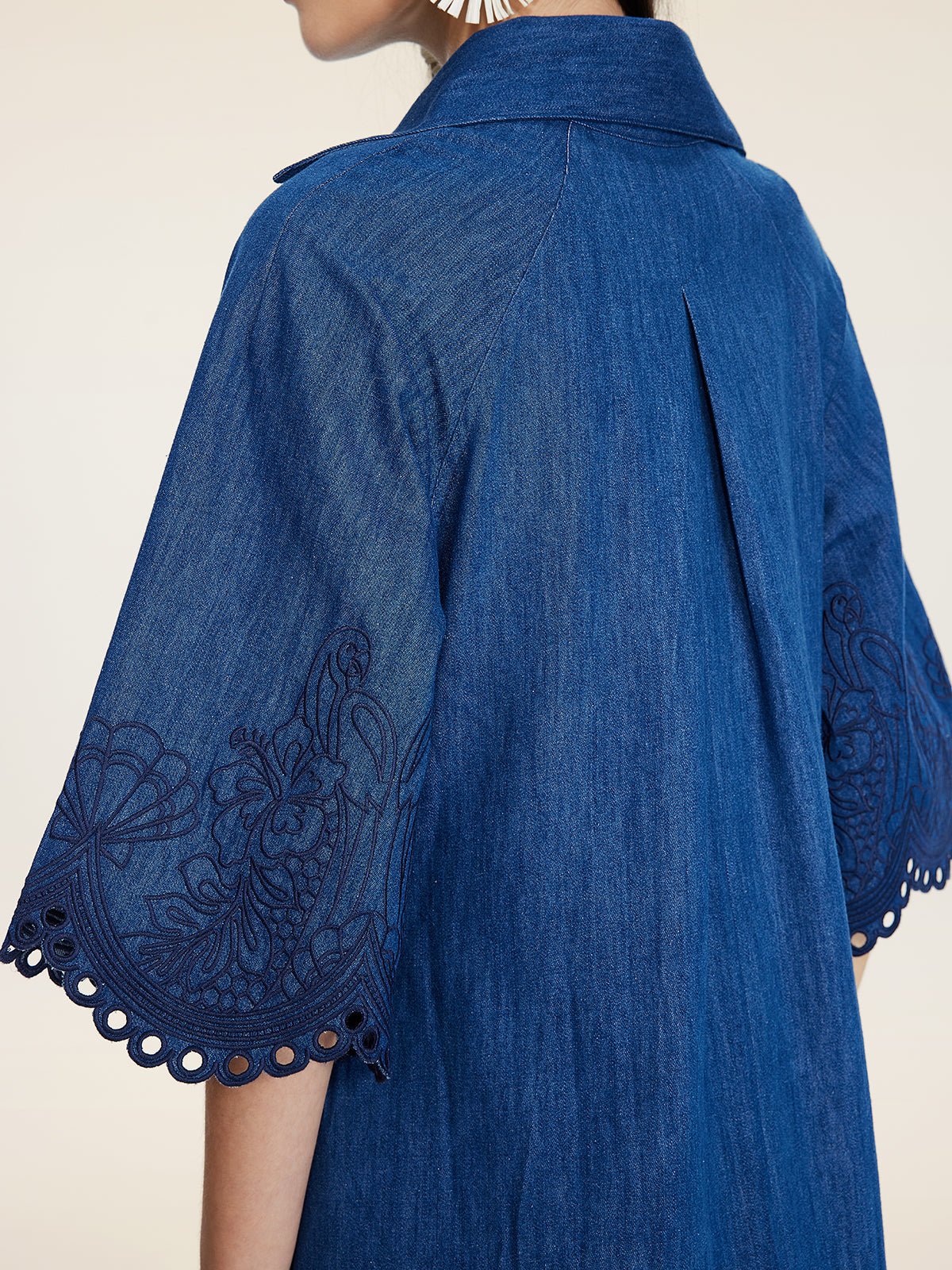 Close-up of a person wearing the Social Queen Embroidered Jacquard Denim Dress, featuring wide sleeves, jacquard embroidery, and scalloped edges for a relaxed fit.