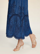 A person wearing the Social Queen Embroidered Jacquard Denim Dress and beige high-heeled sandals.