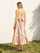 A woman stands outdoors on grass, facing away, wearing the Social Queen Embroidered Jacquard Ruffle Lace-Trim Dress. She has shoulder-length hair and sandals.