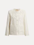 The Social Queen Embroidered Wool Jacket with Pearl Accents features a cream hue, long sleeves, front buttons, hand-embroidered floral chest motifs, satin lining, and two front pockets, showcased on a plain white background.