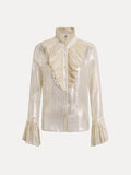 The Social Queen Ethereal Metallic Ruffle Silk Blouse features gold threads, a ruffled high collar, asymmetric front ruffle, and ruffled cuffs, shown on a plain white background.