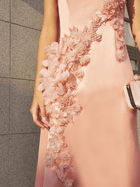 A person wearing the Social Queen Floral Appliqué Satin Fishtail Gown and holding a matching clutch stands in front of a tiled wall.