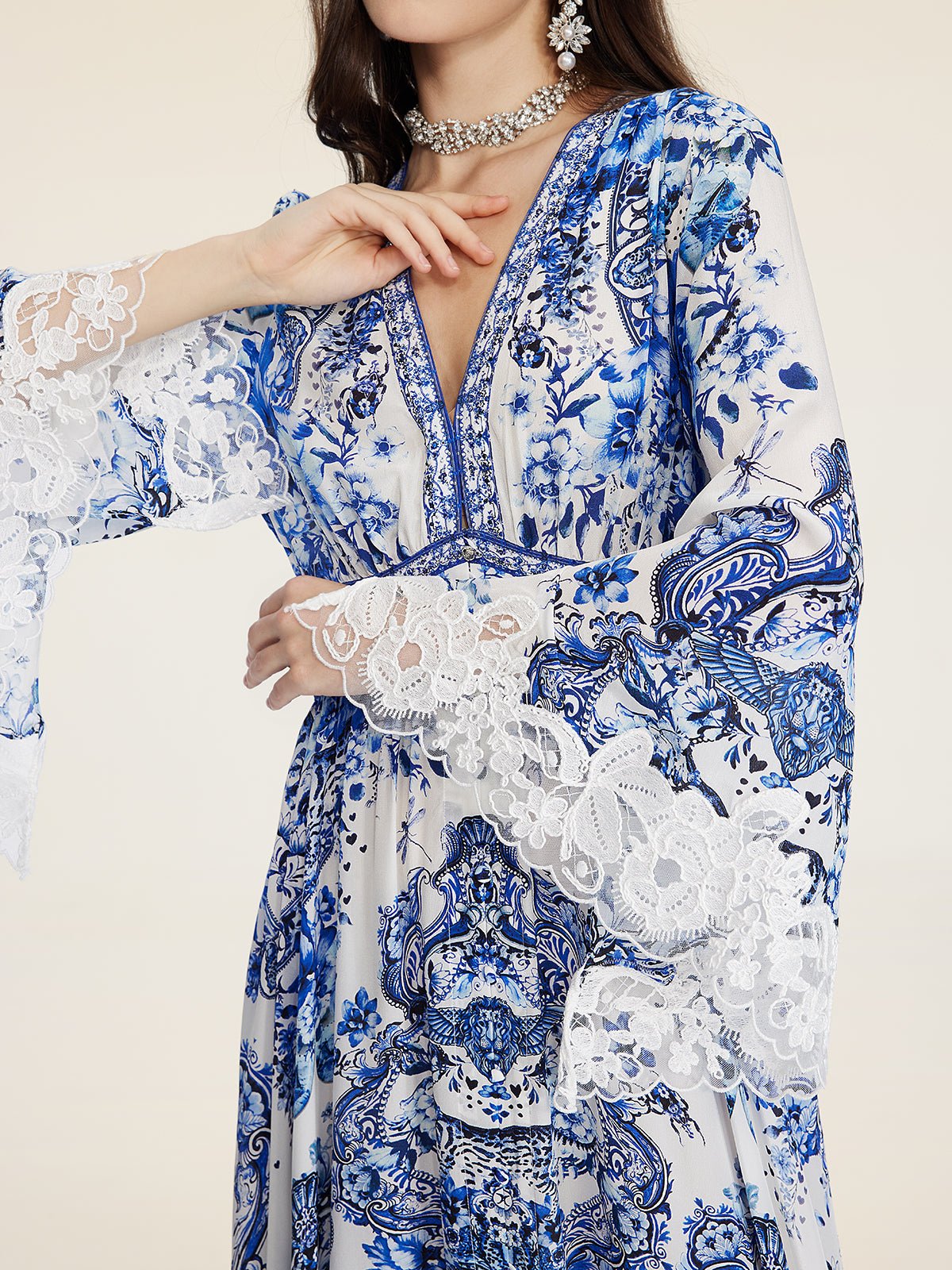 A woman models the Social Queen Floral Embroidered Lantern Sleeve Dress, styled with a jeweled choker and bold floral earrings—an ideal resort wear look for your next elegant escape.
