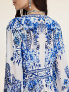 A woman seen from the back wears Social Queen's Floral Embroidered Lantern Sleeve Dress, styled with crystal jewelry.
