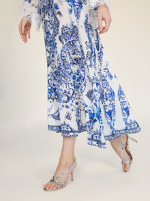 A model wears the Social Queen Floral Embroidered Lantern Sleeve Dress with lace details and silver strappy high-heeled sandals, posing against a plain background.