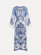 The Social Queen Floral Embroidered Lantern Sleeve Dress features blue and white florals, flared sleeves, lace trim, and intricate detailing, perfect for resort wear and shown on a plain background.