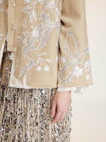 A person wears the Social Queen Floral Embroidered Velvet Jacket, paired with a beige and silver sequin skirt.