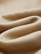 A close-up of soft beige velvet with gentle folds and matte texture, featuring 3D stitching inspired by the Social Queen Floral Embroidered Velvet Jacket.