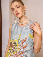 A woman in a Social Queen Floral Jacquard Beaded Sleeveless Dress, paired with a pearl necklace and drop earrings, stands indoors against a plain background.