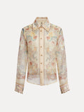 The Social Queen Floral Print Collared Blouse features sheer linen, pastel floral print, long sleeves, a button-up front, pointed collar, and lace-trimmed cuffs and edges.