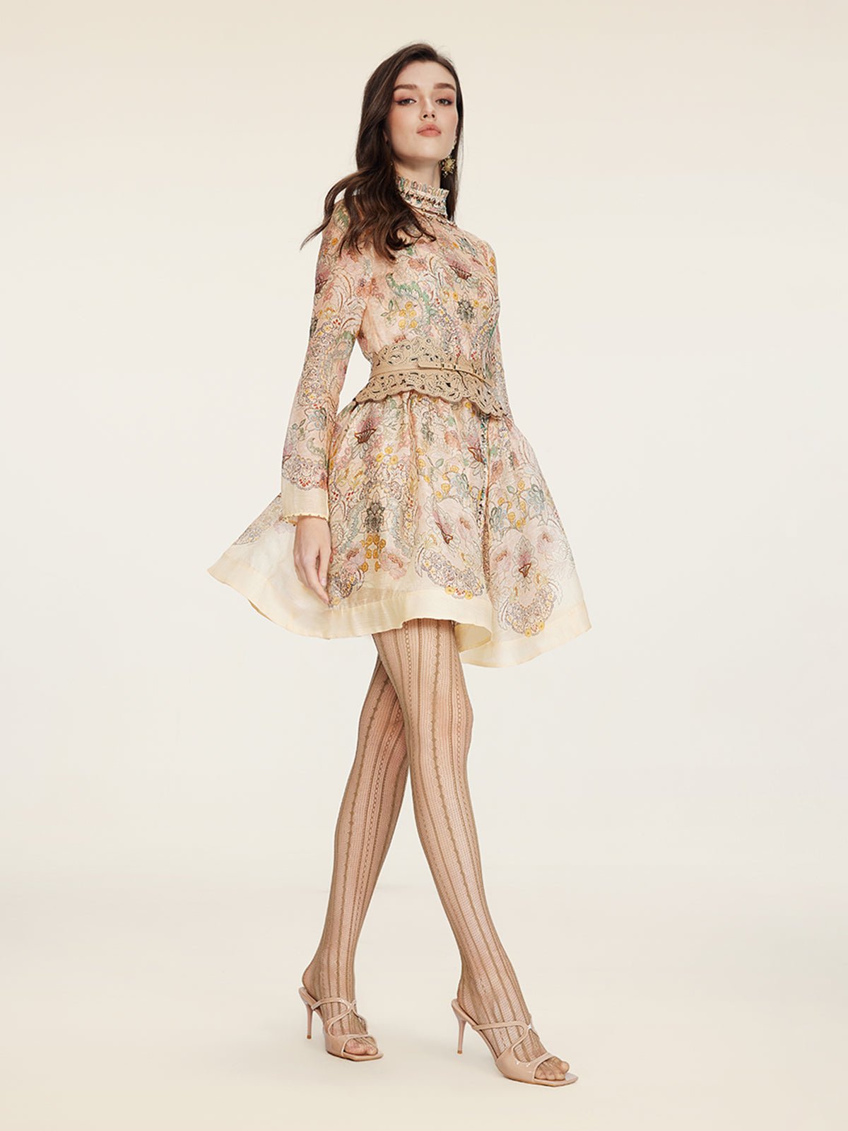 A woman in the Social Queen Floral Print Hand-Beaded Dress stands against a plain light background, styled with patterned tights and open-toe heels.