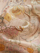 Close-up of Social Queen’s Floral Print Hand-Beaded Dress: light, sheer fabric with pastel yellow, pink, and beige floral and paisley patterns, softly draped and accented with delicate handcrafted lace.