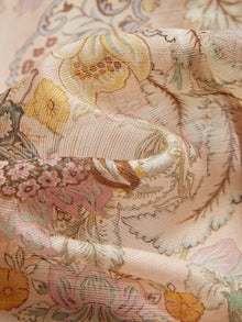 Close-up of Social Queen’s Floral Print Hand-Beaded Dress: light, sheer fabric with pastel yellow, pink, and beige floral and paisley patterns, softly draped and accented with delicate handcrafted lace.