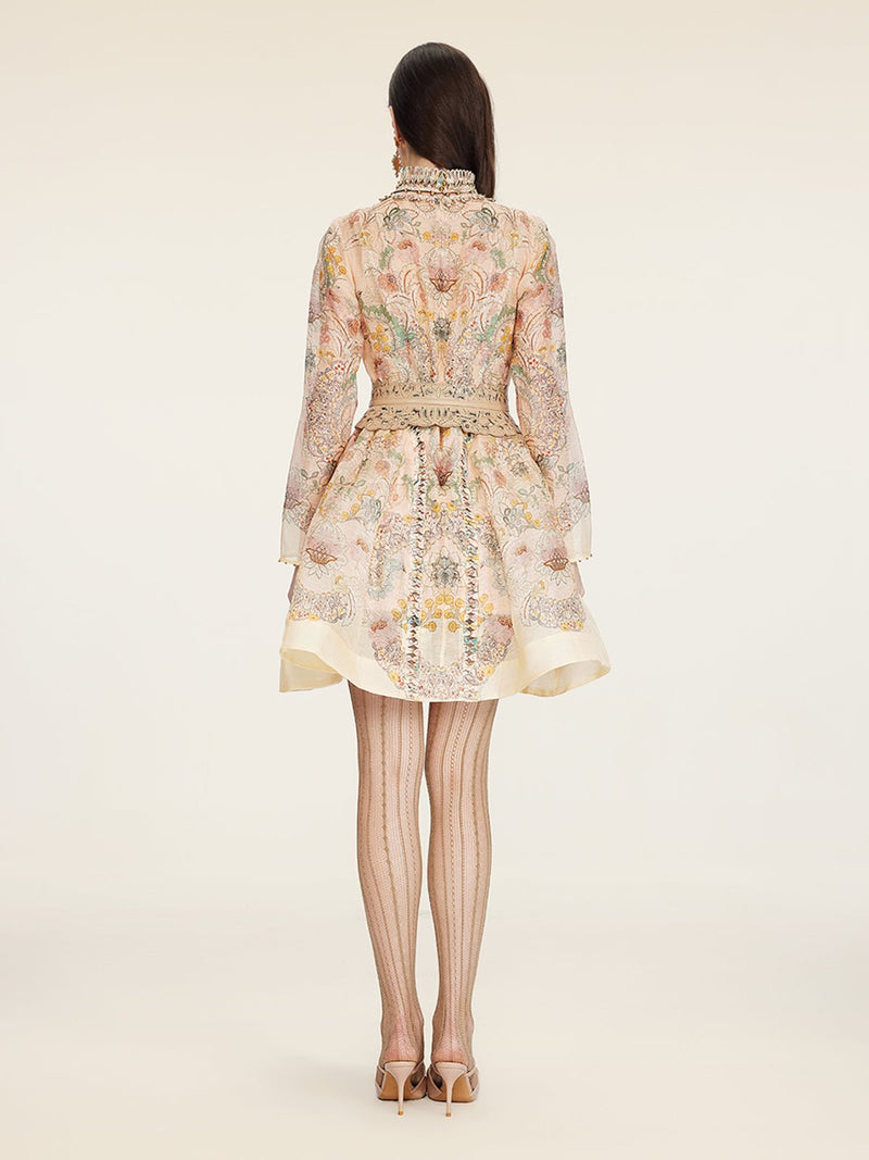 A woman stands facing away, wearing the Social Queen Floral Print Hand-Beaded Dress with sheer patterned tights and high heels, against a plain background.