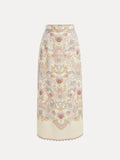 The Social Queen Floral Print Midi Skirt is a vintage-inspired, high-waisted cream linen midi skirt with an intricate floral and paisley pattern in soft pink, blue, and yellow tones.