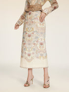 A person wearing the Social Queen Floral Print Midi Skirt with a matching blouse and gold high-heeled sandals stands against a neutral background.
