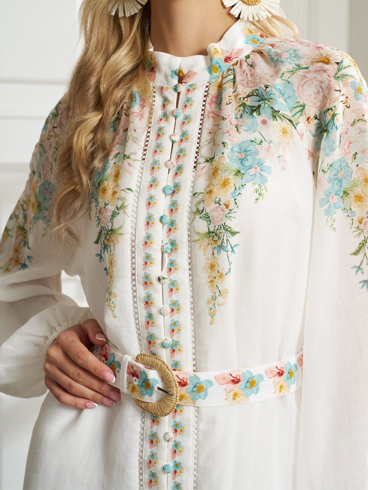 A woman wearing the Social Queen Floral Printed Stand-Collar Dress with a matching floral belt, holding the belt buckle with one hand.