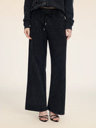 A person is shown from the shoulders down wearing Social Queen Gradient Rhinestone Wide-Leg Pants with an elastic waist, a matching black top, and black heeled sandals against a plain background.