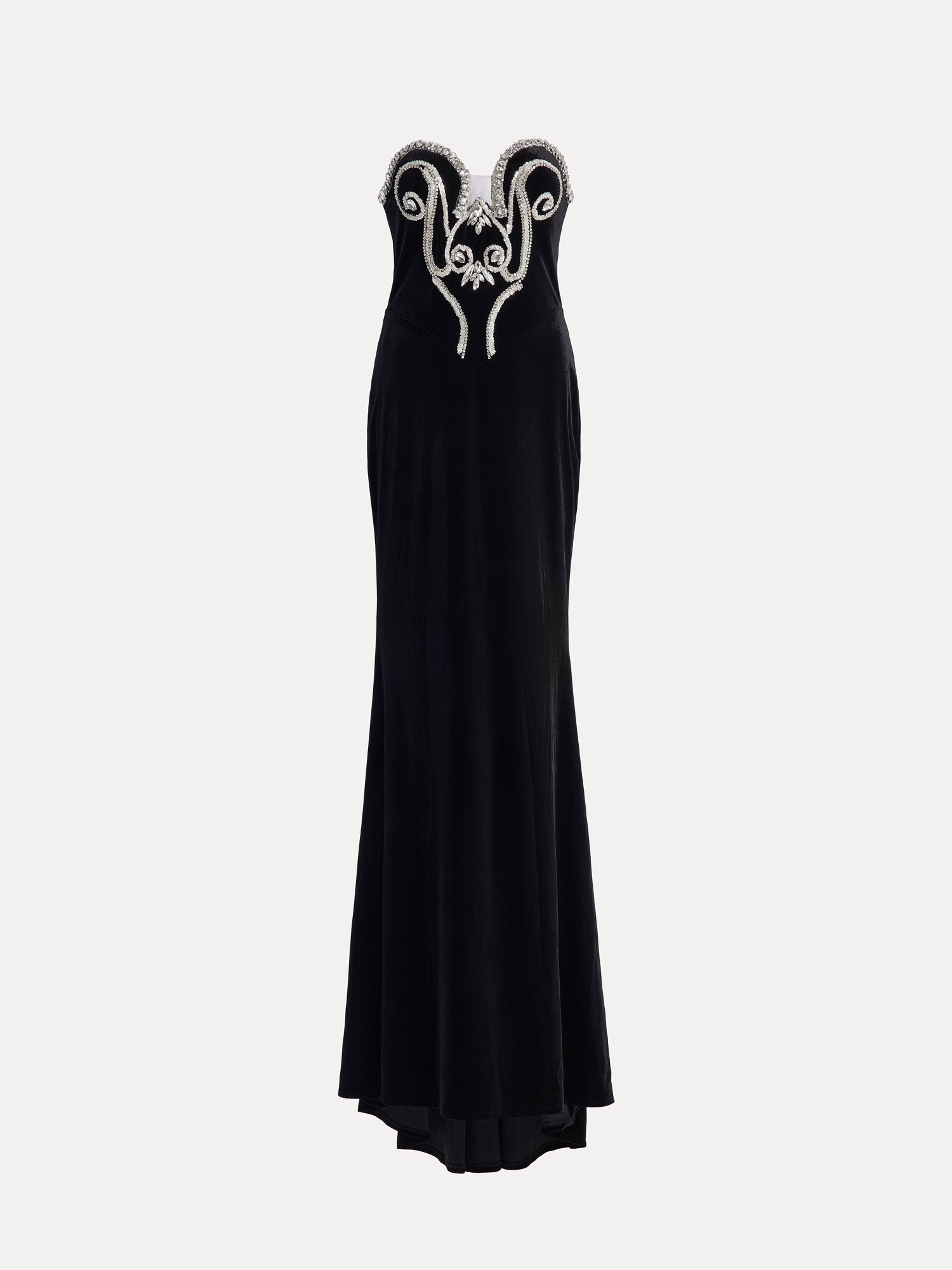 The Social Queen Hand-Applied Silver Crystal Baroque Velvet Gown is a strapless, fitted evening dress with hand-beaded silver crystal swirl details on the chest and a floor-length skirt.