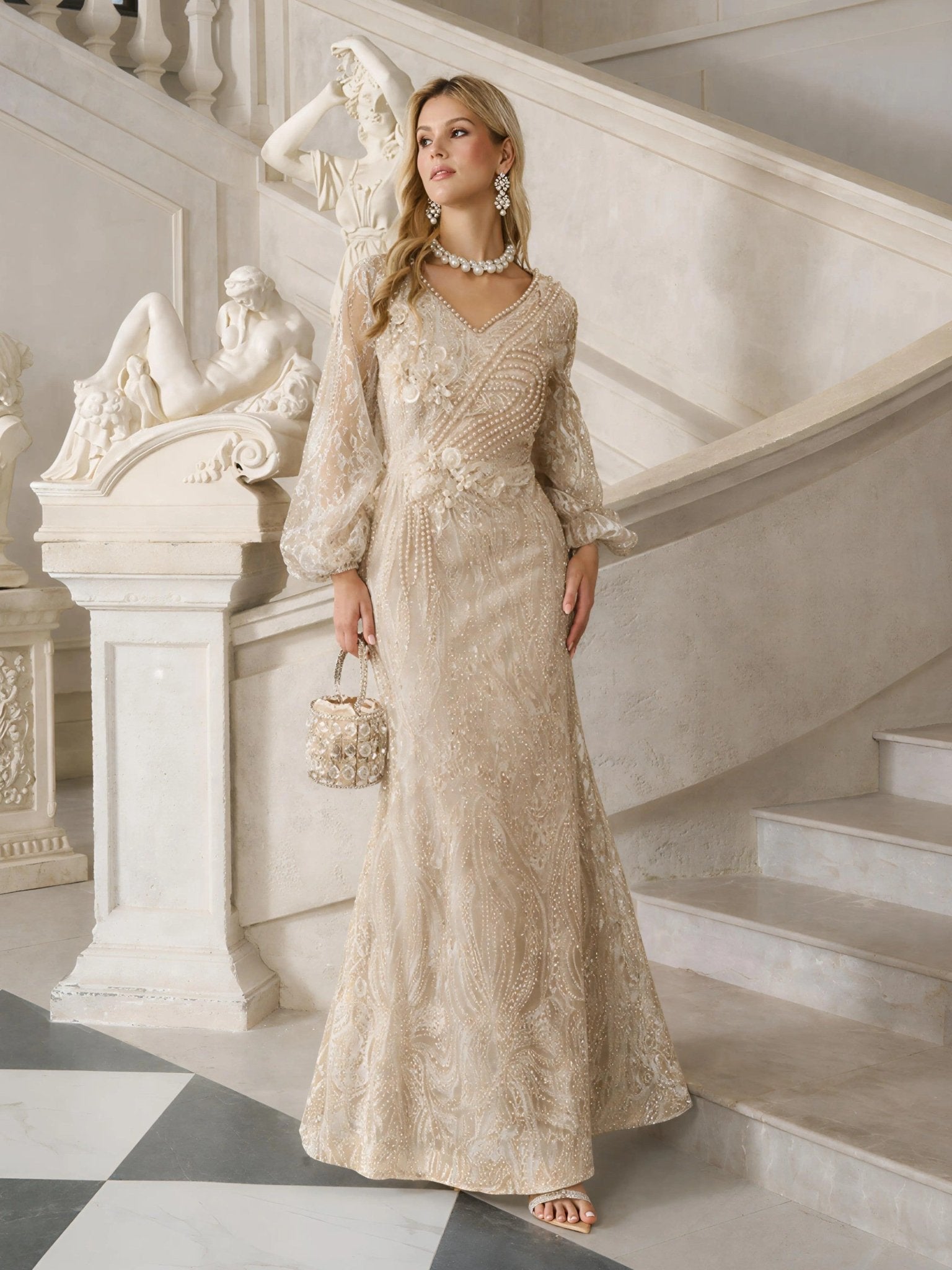 A woman in the Social Queen Hand-Beaded Lace Mermaid Dress stands on marble steps, holding a matching purse, with classical statues and architectural details behind her.