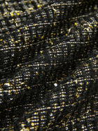 Close-up of hand-beaded detailing on Social Queen's Hand-Beaded Tweed Fringe Jacket, featuring gold and white threads and sequins forming a grid-like pattern on black-and-gold tweed.
