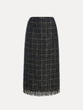 The Hand-Beaded Tweed Fringe Slit Skirt by Social Queen is a knee-length, straight-cut black-and-gold tweed skirt with hand-applied beadwork and a fringed hem, displayed against a plain white background.