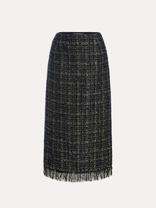 The Hand-Beaded Tweed Fringe Slit Skirt by Social Queen is a knee-length, straight-cut black-and-gold tweed skirt with hand-applied beadwork and a fringed hem, displayed against a plain white background.