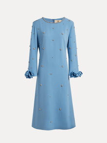 The Social Queen Handcrafted Beaded Floral A-Line Dress features a knee-length blue design with long sleeves, hand-beaded floral embellishments, and ruffled cuffs, shown against a white background.